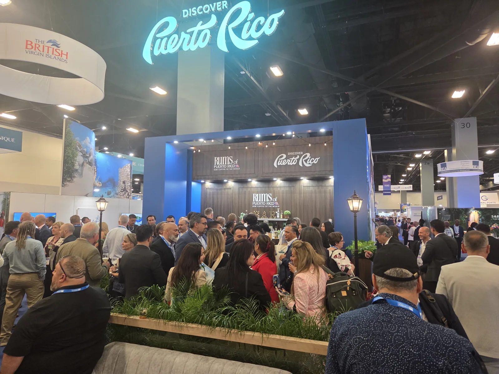The Discover Puerto Rico booth at Seatrade — lights, crowd, and the Rums of Puerto Rico bar.